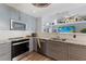 Updated kitchen showcases granite counters, white subway tile backsplash, and modern stainless steel appliances at 3889 Canopy Way, Sarasota, FL 34235