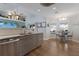 Open concept kitchen featuring stainless steel appliances, tile backsplash, and adjacent dining area at 3889 Canopy Way, Sarasota, FL 34235