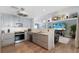 Open concept kitchen features stainless steel appliances, granite counters, and seamless flow to a bright living space at 3889 Canopy Way, Sarasota, FL 34235