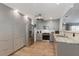 Modern kitchen with stainless steel appliances, gray cabinets, and stylish granite countertops at 3889 Canopy Way, Sarasota, FL 34235