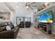 Open living room with beach accents, a large screen TV, and comfortable leather sofas at 3889 Canopy Way, Sarasota, FL 34235