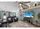 Inviting living room features a large screen TV and comfortable leather seating at 3889 Canopy Way, Sarasota, FL 34235