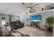 Comfortable living room featuring modern furnishings, a decorative ceiling fan, and beach-themed accents at 3889 Canopy Way, Sarasota, FL 34235