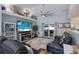 Bright living room featuring access to the patio, a large screen TV, and beach-themed decor at 3889 Canopy Way, Sarasota, FL 34235