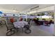 Spacious covered patio with a dining area, ceiling fan, and outdoor seating near the manicured backyard at 3889 Canopy Way, Sarasota, FL 34235