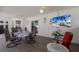Inviting patio area featuring comfortable seating, a dining table, and a mounted TV for entertainment at 3889 Canopy Way, Sarasota, FL 34235