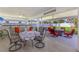 Charming patio area with dining and seating areas, a ceiling fan, and ample outdoor living space at 3889 Canopy Way, Sarasota, FL 34235
