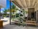 Spacious outdoor patio with ample seating, lush plants and ample shade making it an inviting gathering spot at 430 Kumquat Ct # 202, Sarasota, FL 34236
