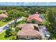 Overhead view of house featuring solar panels, screened in pool, manicured lawn, and tiled roof at 4356 Highland Oaks Cir # 3, Sarasota, FL 34235