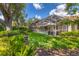 Beautiful backyard features a screened-in pool area, lush landscaping, and a well-maintained lawn at 4356 Highland Oaks Cir # 3, Sarasota, FL 34235