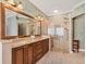 Elegant bathroom featuring a double vanity with granite counters and glass enclosed shower at 4356 Highland Oaks Cir # 3, Sarasota, FL 34235