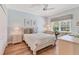 Bright bedroom with hardwood floors, a white ceiling fan, and blue painted walls at 4356 Highland Oaks Cir # 3, Sarasota, FL 34235