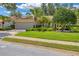 Exterior of home with well-manicured lawn and landscaping at 4356 Highland Oaks Cir # 3, Sarasota, FL 34235