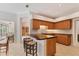 Kitchen featuring wooden cabinets, an island with a breakfast bar and floral wallpaper at 4356 Highland Oaks Cir # 3, Sarasota, FL 34235