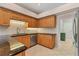 Kitchen showcasing wood cabinets, stainless steel dishwasher, and tile floors at 4356 Highland Oaks Cir # 3, Sarasota, FL 34235