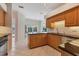 Kitchen featuring granite countertops, stainless steel dishwasher, and wood cabinets at 4356 Highland Oaks Cir # 3, Sarasota, FL 34235