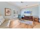 Comfortable living room with hardwood floors, plantation shutters, and a plush leather sofa at 4356 Highland Oaks Cir # 3, Sarasota, FL 34235