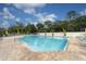 Outdoor pool with lounge chairs, umbrellas, pool-side plants, and trees at 4356 Highland Oaks Cir # 3, Sarasota, FL 34235