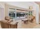 Sun room with rattan furniture and access to the outdoor pool area at 4356 Highland Oaks Cir # 3, Sarasota, FL 34235