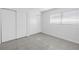 Well-lit bedroom features tile flooring and a closet with sliding doors at 4444 Swift Rd # 25, Sarasota, FL 34231