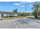 Charming condo complex featuring blue doors and shutters surrounded by lush green landscaping and ample parking at 4444 Swift Rd # 25, Sarasota, FL 34231
