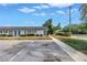 Charming condo complex featuring blue doors and shutters surrounded by lush green landscaping and ample parking at 4444 Swift Rd # 25, Sarasota, FL 34231