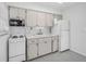 Bright kitchen features white cabinets, appliances, and a tile backsplash at 4444 Swift Rd # 25, Sarasota, FL 34231