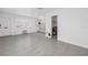 Open-concept living room flows into the kitchen with neutral tile flooring at 4444 Swift Rd # 25, Sarasota, FL 34231