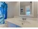 Bright bathroom featuring a new vanity, a large mirror, and a colorful shower curtain at 446 Cerromar Rd # 291, Venice, FL 34293