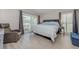 Bright bedroom featuring a recliner, a large bed, and balcony access with views of the outdoors at 446 Cerromar Rd # 291, Venice, FL 34293