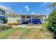 A carport with a parking spot and a meticulously landscaped outdoor space at 446 Cerromar Rd # 291, Venice, FL 34293