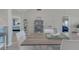Cozy dining area offers modern table and seating with view of bedrooms with blue decor and shelf decor at 446 Cerromar Rd # 291, Venice, FL 34293