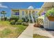 Charming two-story condo building featuring lush landscaping and classic architectural details, creating a welcoming curb appeal at 446 Cerromar Rd # 291, Venice, FL 34293