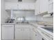 Efficient white kitchen with a practical layout, designed for functionality and ease of use at 446 Cerromar Rd # 291, Venice, FL 34293