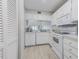 Bright white kitchen with ample storage and modern appliances, creating a clean and efficient cooking space at 446 Cerromar Rd # 291, Venice, FL 34293