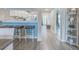 Bright kitchen view with barstool seating, white cabinets, stainless steel appliances, and modern flooring at 446 Cerromar Rd # 291, Venice, FL 34293