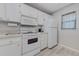 Clean white kitchen with modern appliances, offering a bright and functional cooking area at 446 Cerromar Rd # 291, Venice, FL 34293