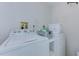Laundry room featuring new white washer and dryer units and modern accessories at 446 Cerromar Rd # 291, Venice, FL 34293