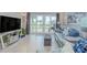 Open living room shows sliding glass doors to lanai, vaulted ceiling, comfortable seating, and TV at 446 Cerromar Rd # 291, Venice, FL 34293