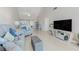 Spacious living room with vaulted ceiling, TV, comfortable seating, and easy access to kitchen at 446 Cerromar Rd # 291, Venice, FL 34293