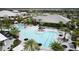 Overhead view of pool and community area with seating, palm trees, and clubhouse at 4750 Tortona Ct, Bradenton, FL 34211