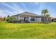 Spacious backyard with lush green lawn and screened-in lanai at 4750 Tortona Ct, Bradenton, FL 34211