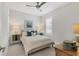 Charming bedroom features neutral tones, fan, a window for natural light and decorative furnishings at 4750 Tortona Ct, Bradenton, FL 34211