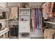 Walk-in closet features custom shelving, hanging rods, drawers and ample space for organization at 4750 Tortona Ct, Bradenton, FL 34211