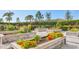 View of raised garden beds with colorful flowers and various plantings in a community garden at 4750 Tortona Ct, Bradenton, FL 34211