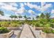 Charming community garden with lush landscaping, raised garden beds, and a beautiful paver walkway at 4750 Tortona Ct, Bradenton, FL 34211