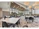 Bright dining area with ample seating, large windows offering beautiful views, and elegant overhead lighting at 4750 Tortona Ct, Bradenton, FL 34211