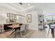 Bright dining room with stylish table, decor, and open view to the kitchen and living area at 4750 Tortona Ct, Bradenton, FL 34211