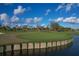 Scenic golf course view with a water hazard and manicured green, showcasing the community's recreational amenities at 4750 Tortona Ct, Bradenton, FL 34211
