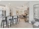 Modern kitchen features stainless steel appliances, sleek countertops, bar seating, and open dining area at 4750 Tortona Ct, Bradenton, FL 34211